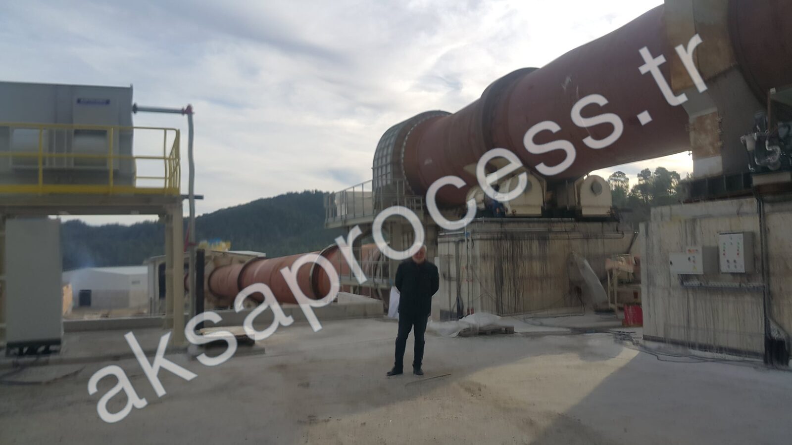 Our founder on site in front of a rotary kiln line during commissioning