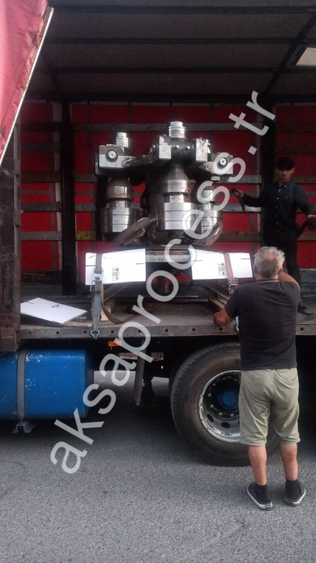 The team securing a machined classifier rotor on a truck for dispatch